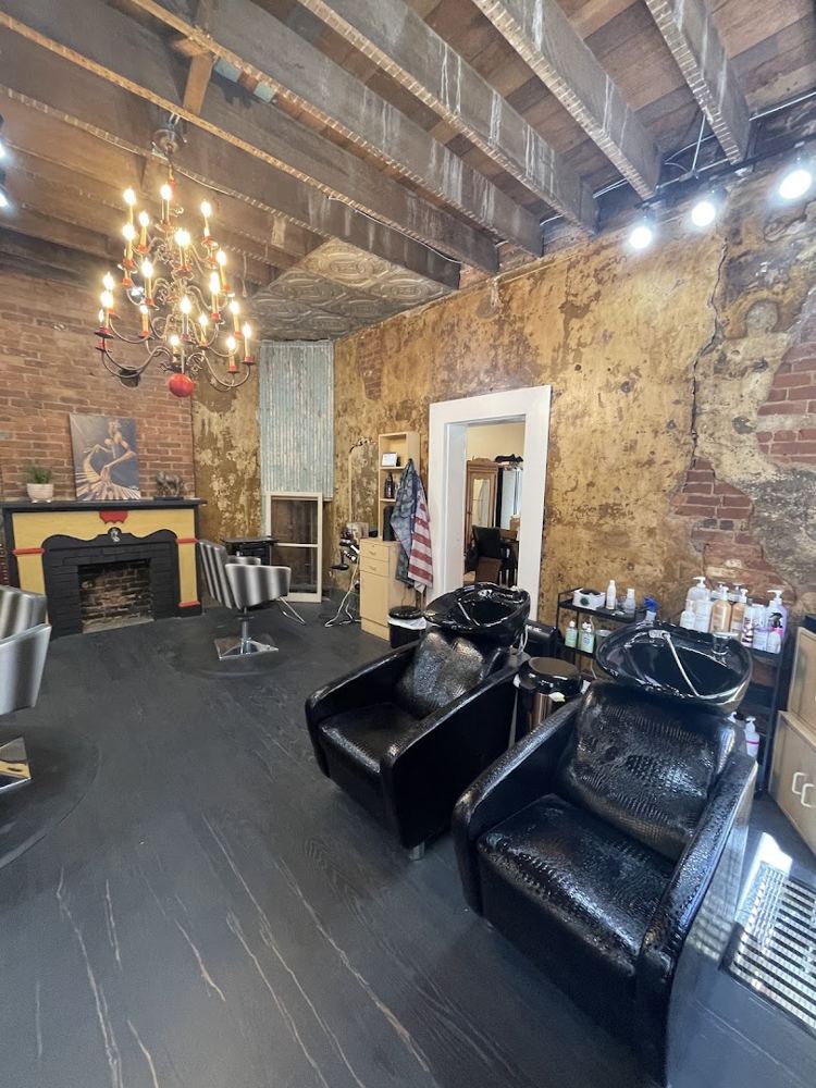Shampoo stations under a chandelier and exposed beams
